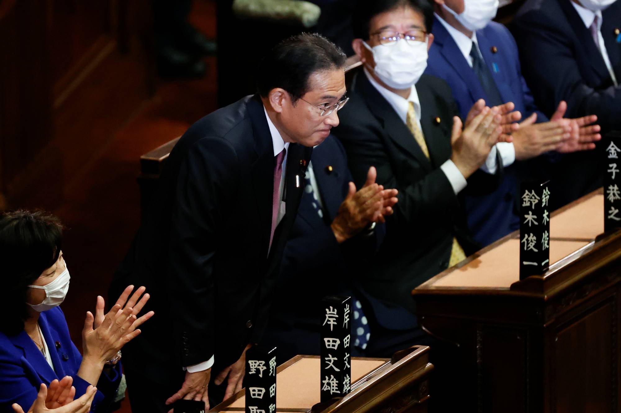 Prime Minister Fumio Kishida is applauded after being re-elected as prime minister by the Lower House in Tokyo on Wednesday.  |  REUTERS