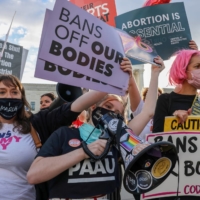 Pro-choice and anti-abortion protesters demonstrate outside the U.S. Supreme Court as the court hears arguments over a challenge to a Texas law that bans abortion after six weeks. | REUTERS