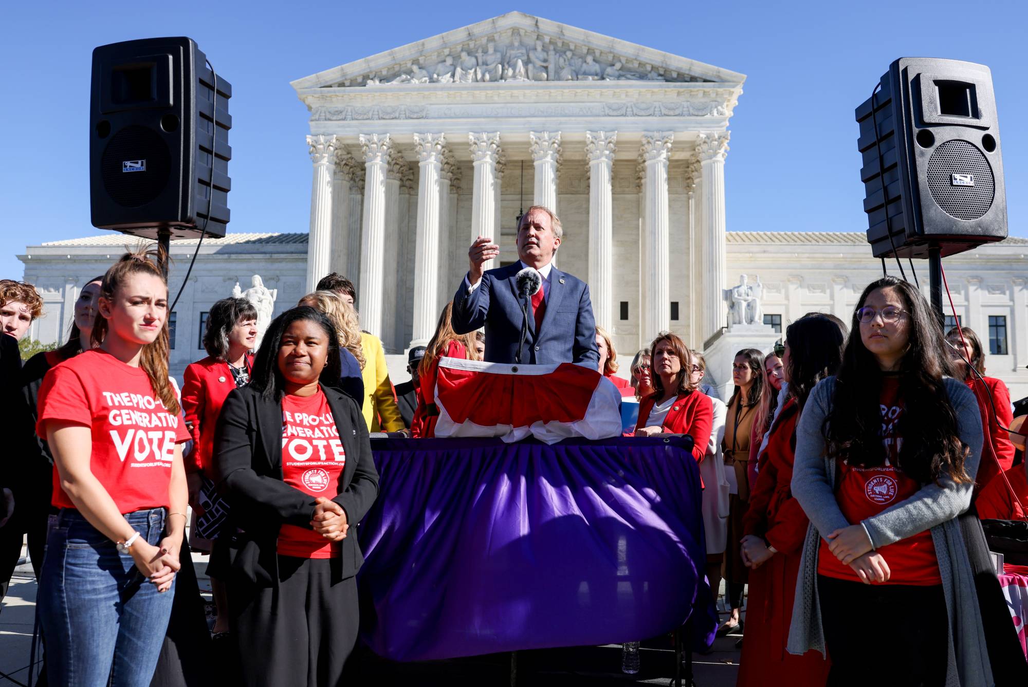 Texas Attorney General Ken Paxton speaks to a crowd of anti-abortion supporters outside the U.S. Supreme Court. | Reuters