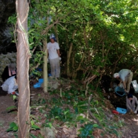 Researchers engage in archaeological excavations at the Nagabaka site on Miyako Island, Okinawa Prefecture, as part of a study that explored the origins of the trans-Eurasian languages. | MARK HUDSON / VIA REUTERS
