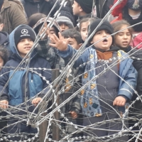 Migrants children gather near a fence on the border between Poland and Belarus near Kuznica, Poland, in this video-still released by the Polish Interior Ministry on Thursday. | MON / VIA REUTERS