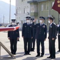 Defense Minister Nobuo Kishi (front right) inspects the Hofu Kita Air Base in Hofu, Yamaguchi Prefecture, on Sunday. | KYODO