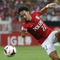Urawa\'s Yuki Abe (left) competes against Arsenal\'s Theo Walcott during a friendly in Saitama in July 2013. | REUTERS