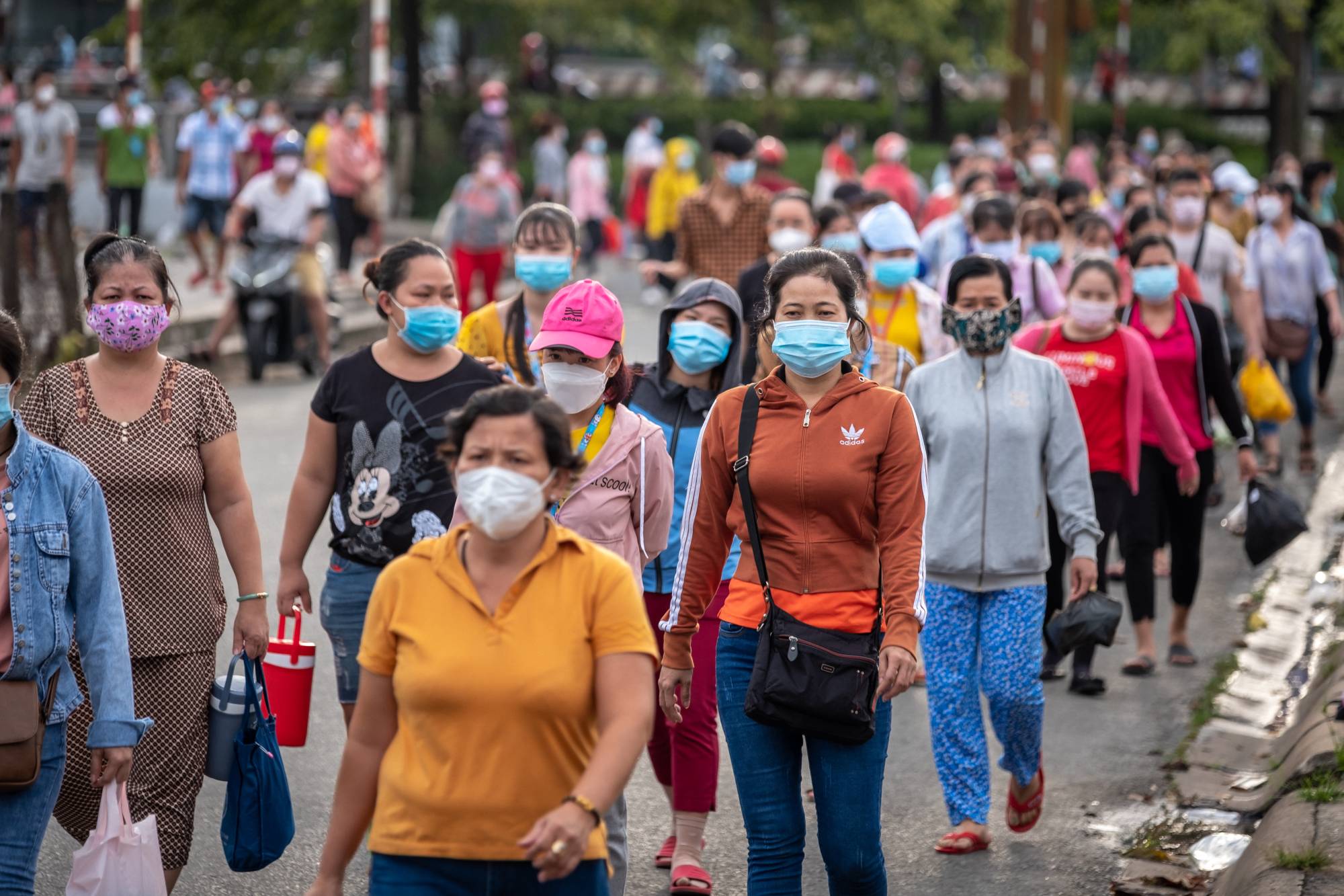 Employees leave a factory after a shift in Ho Chi Minh City, Vietnam. | LINH PHAM / THE NEW YORK TIMES
