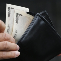 Naoko Kuga, a senior researcher at the NLI Research Institute and an expert on consumer behavior, says weak purchasing power stemming from stagnant wages have seen corporations hesitant to raise prices. | REUTERS