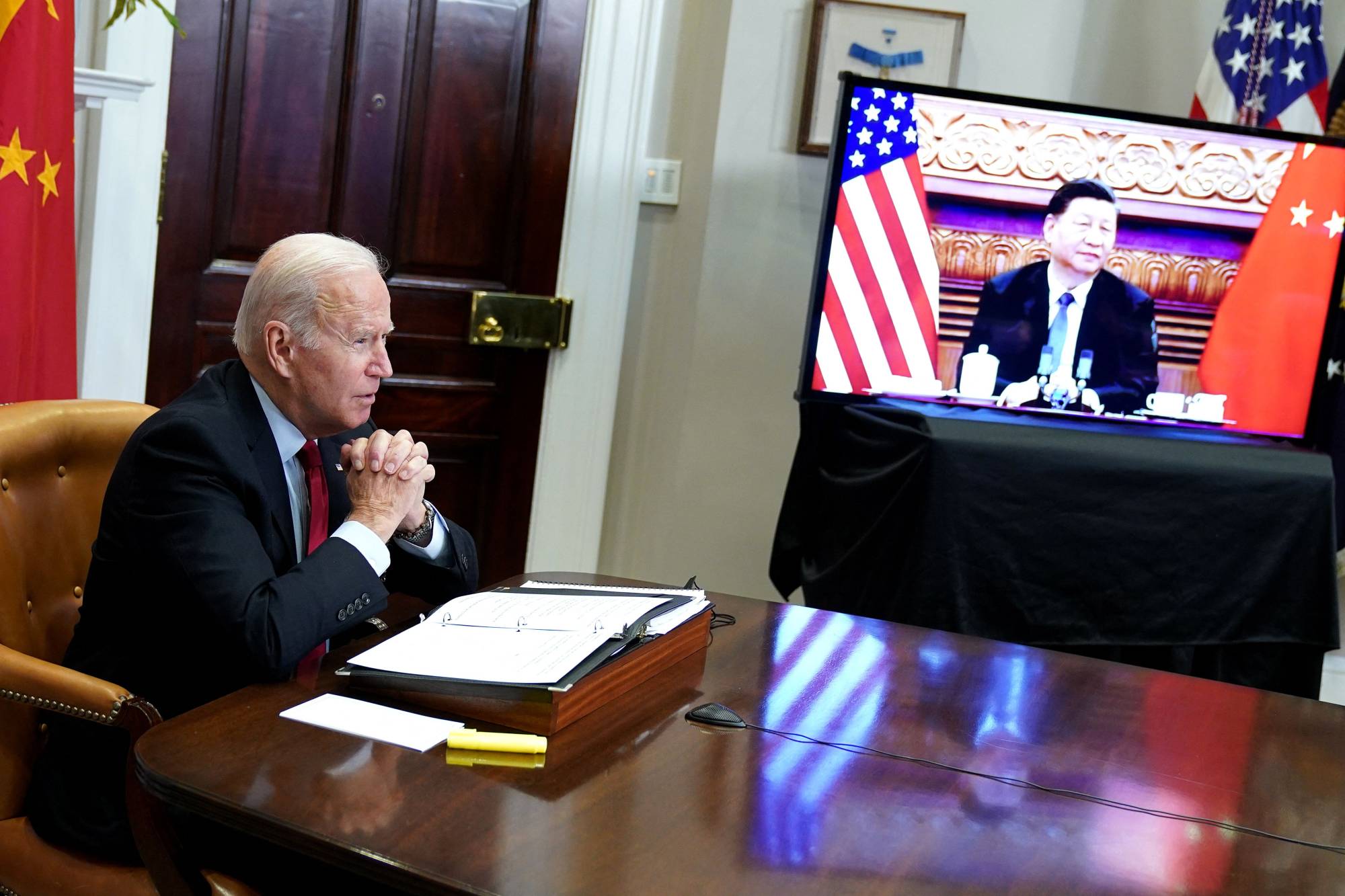 U.S. President Joe Biden meets with Chinese leader Xi Jinping during a virtual summit from the Roosevelt Room of the White House in Washington on Monday. | AFP-JIJI