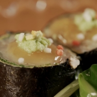 A dish of crab meat wrapped in \"nori\" seaweed, garnished with colorful \"arare\" rice crackers. Takamura serves seafood from the nearby Sea of Japan.  | NAOH INC.
