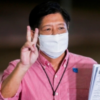 Ferdinand Marcos Jr, the son of late Philippines dictator Ferdinand Marcos, poses for pictures after filing his certificate of candidacy for president in the 2022 national election, in Pasay City, Metro Manila, on Oct. 6. | POOL / VIA REUTERS