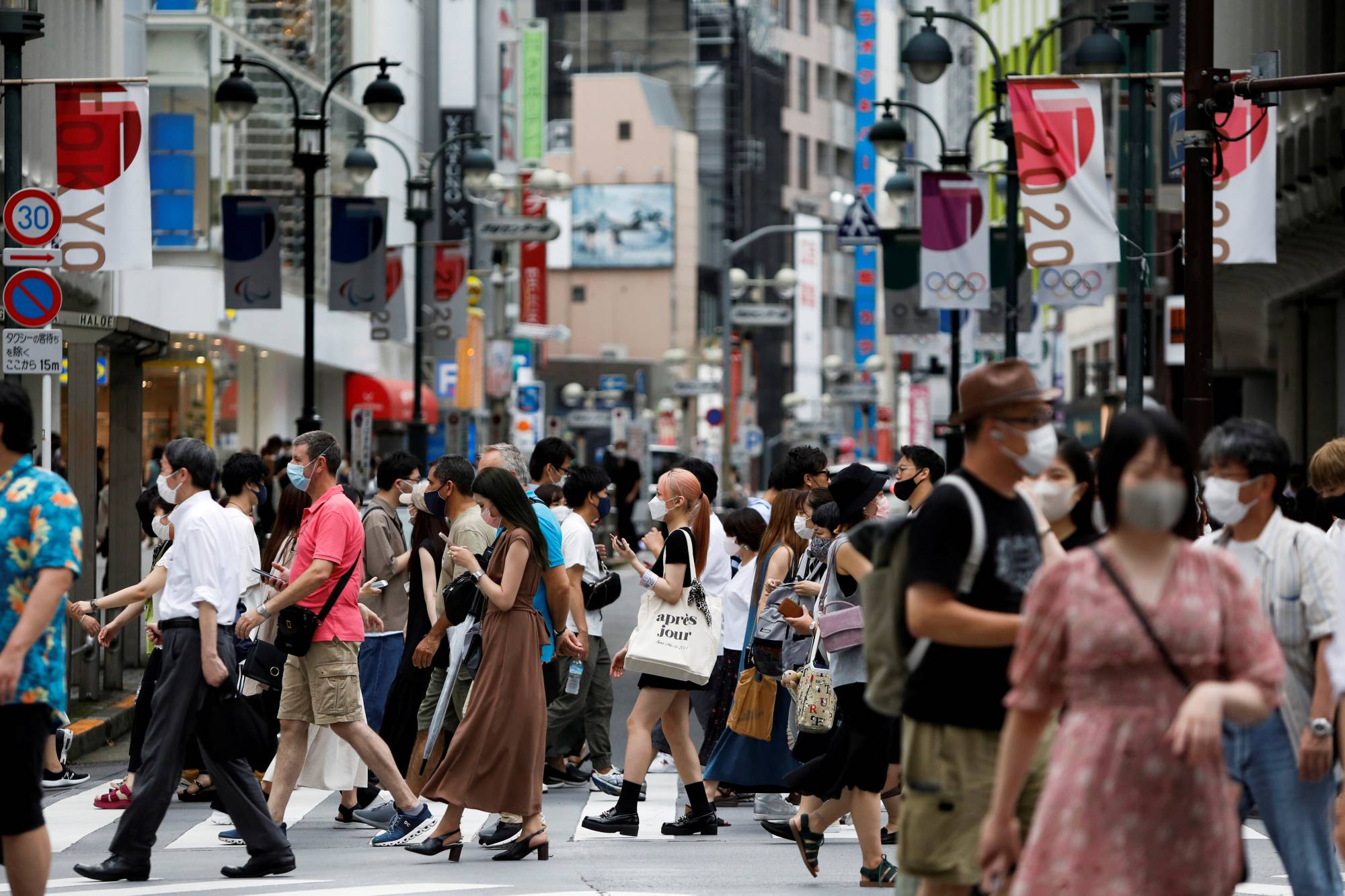 Pedestrians at a crossing in a shopping area of Shibuya Ward, Tokyo, on Aug. 7. | REUTERS
