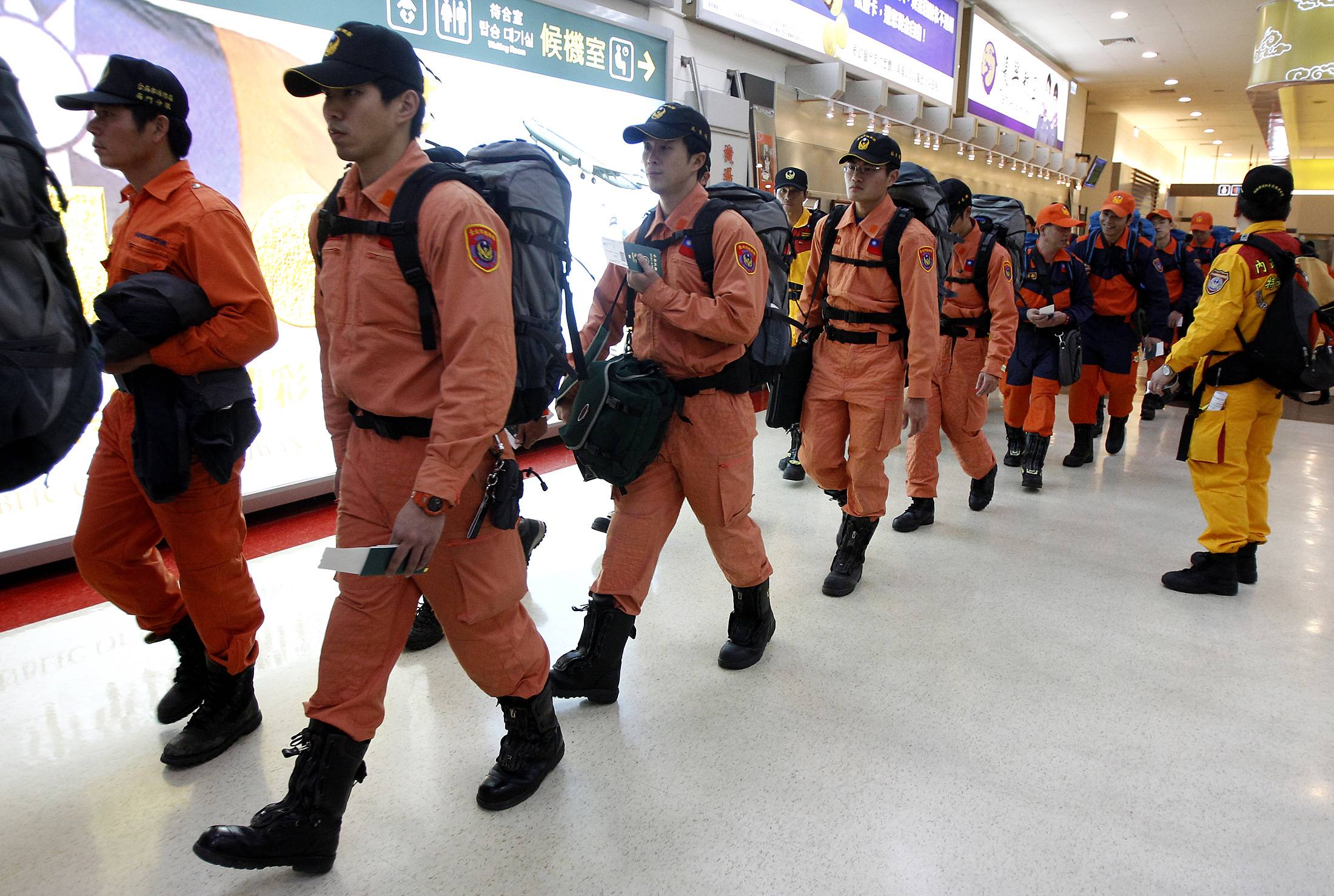 A Taiwanese earthquake search and rescue team prepares to depart Taipei's Songshan Airport for Japan to help find survivors after the Great East Japan Earthquake in March 2011. | REUTERS