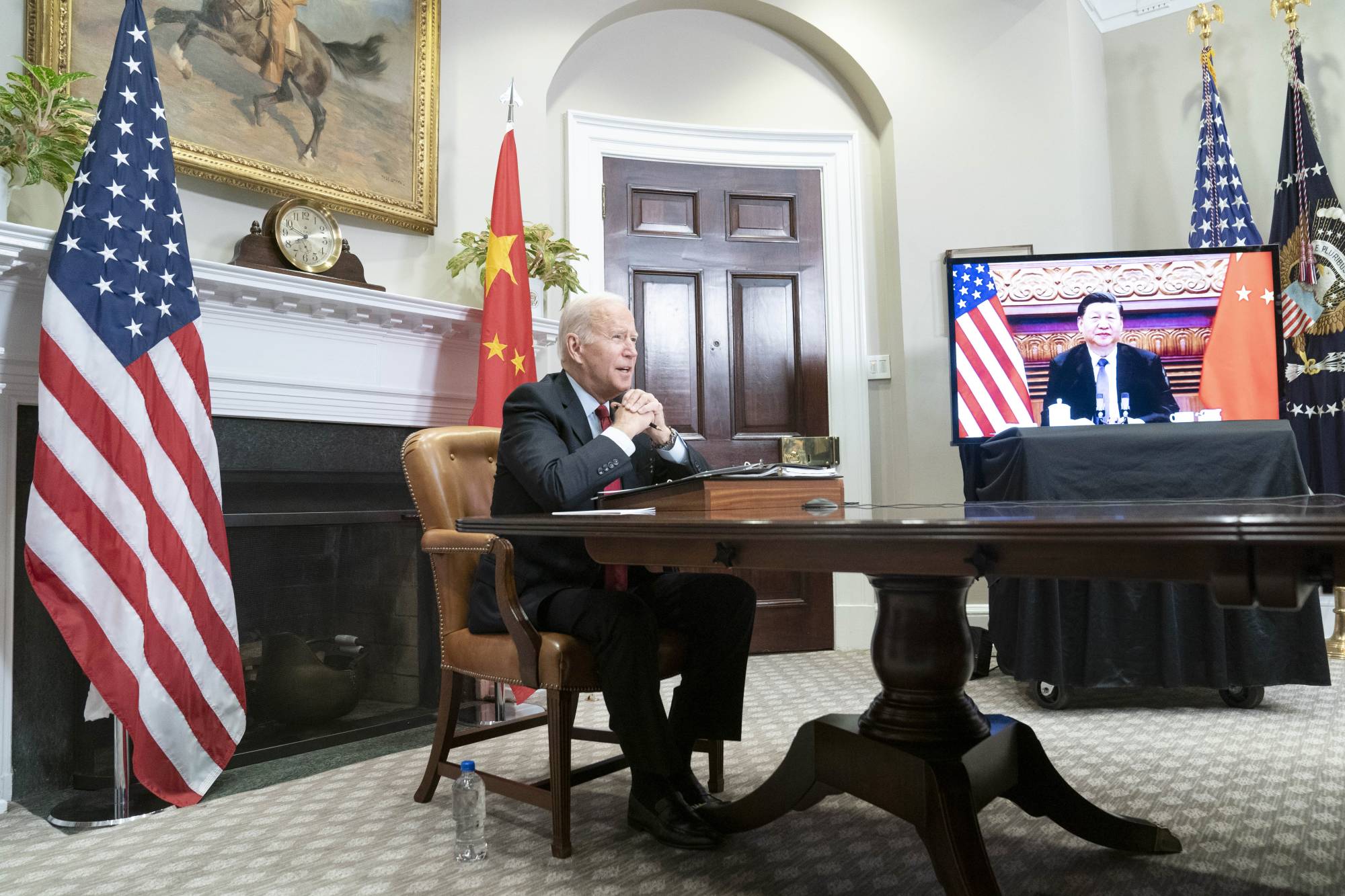 U.S. President Joe Biden speaks with Chinese President Xi Jinping from the White House during their virtually meeting on Monday.   | BLOOMBERG