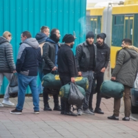Migrants congregate at a market in Minsk on Saturday. Iraqi Kurds and other migrants said they were fleeing despair at home, but Belarus encouraged them to come, offering visas and helping them get to the border with other European countries.  | THE NEW YORK TIMES