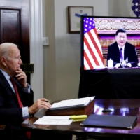 U.S. President Joe Biden speaks virtually with Chinese leader Xi Jinping from the White House in Washington on Monday. | REUTERS
