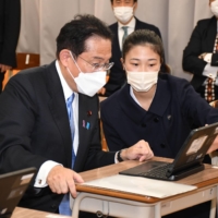 Prime Minister Fumio Kishida visits a high school in Matsuyama, Ehime Prefecture, on Saturday. | POOL / VIA KYODO