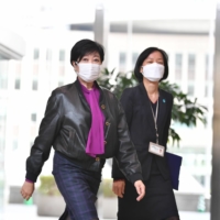 Tokyo Gov. Yuriko Koike, after being hospitalized last month, makes her first public appearance at the Tokyo Metropolitan Government building for an online meeting of the National Governors’ Association on Sunday. | RYUSEI TAKAHASHI
