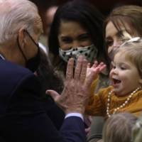 U.S. President Joe Biden high fives 16-month-old Breklyn Petroelje as he gathers with U.S. service members and military families during a Thanksgiving event at Fort Bragg in North Carolina on Monday. | REUTERS