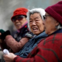 Elderly women at a park in downtown Shanghai. China’s birthrate fell to a new low in 2020, confirming the demographic challenge facing the government as it tries to deal with a shrinking labor force and growing population of elderly people. | REUTERS