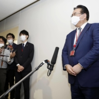 NTT Docomo Inc. President and CEO Motoyuki Ii speaks to reporters Friday at the communications ministry after the ministry issued an administrative order to the firm. | KYODO