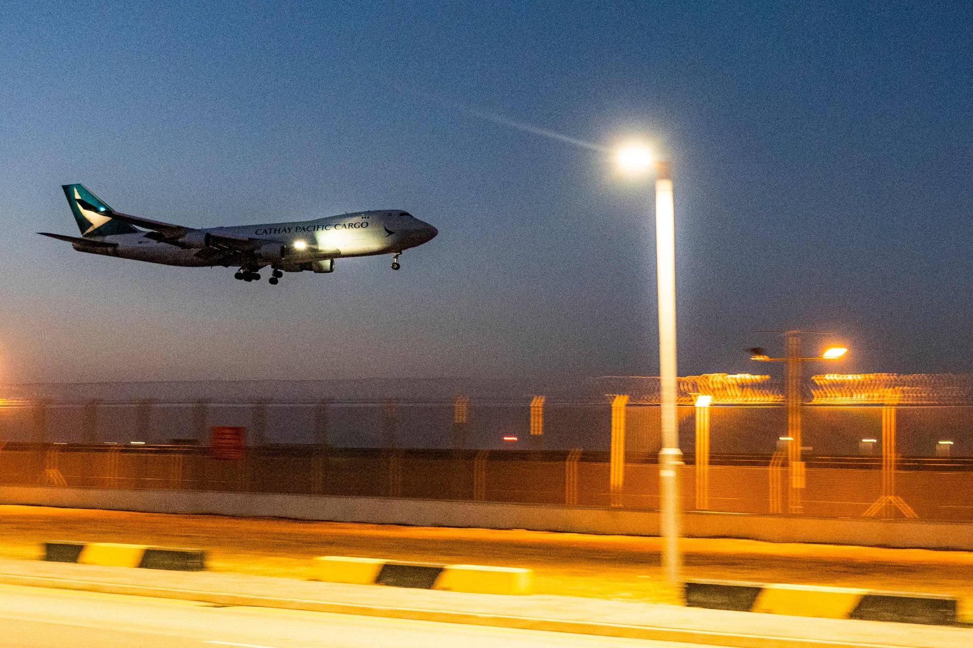A Cathay Pacific cargo airplane prepares to land at Hong Kong International Airport on Nov. 20.  | AFP-JIJI