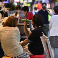 A customer drinks beer at a restaurant in Kobe on June 21. | KYODO