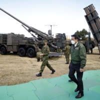 Prime Minister Fumio Kishida inspects military equipment during a review at Camp Asaka in Tokyo on Saturday.

 | BLOOMBERG