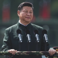 Chinese President Xi Jinping inspects People\'s Liberation Army soldiers at a barracks in Hong Kong in June 2017. | DALE DE LA REY / AFP / VIA GETTY IMAGES