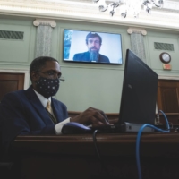 Twitter CEO Jack Dorsey appears on a monitor behind a stenographer as he testifies remotely during a Senate hearing on Big Tech in Washington on Oct. 28, 2020. | MICHAEL REYNOLDS / POOL / GETTY IMAGES
