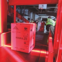 Boxes containing the first shipments of the Pfizer COVID-19 vaccine are unloaded from air shipping containers and scanned at UPS Worldport in Louisville, Kentucky, on Dec. 13, 2020.  | MICHAEL CLEVENGER / POOL / GETTY IMAGES