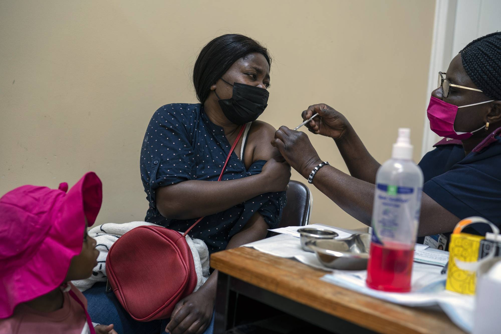 A woman receives a dose of COVID-19 vaccine in Johannesburg on Tuesday. | Joao Silva / The New York Times
