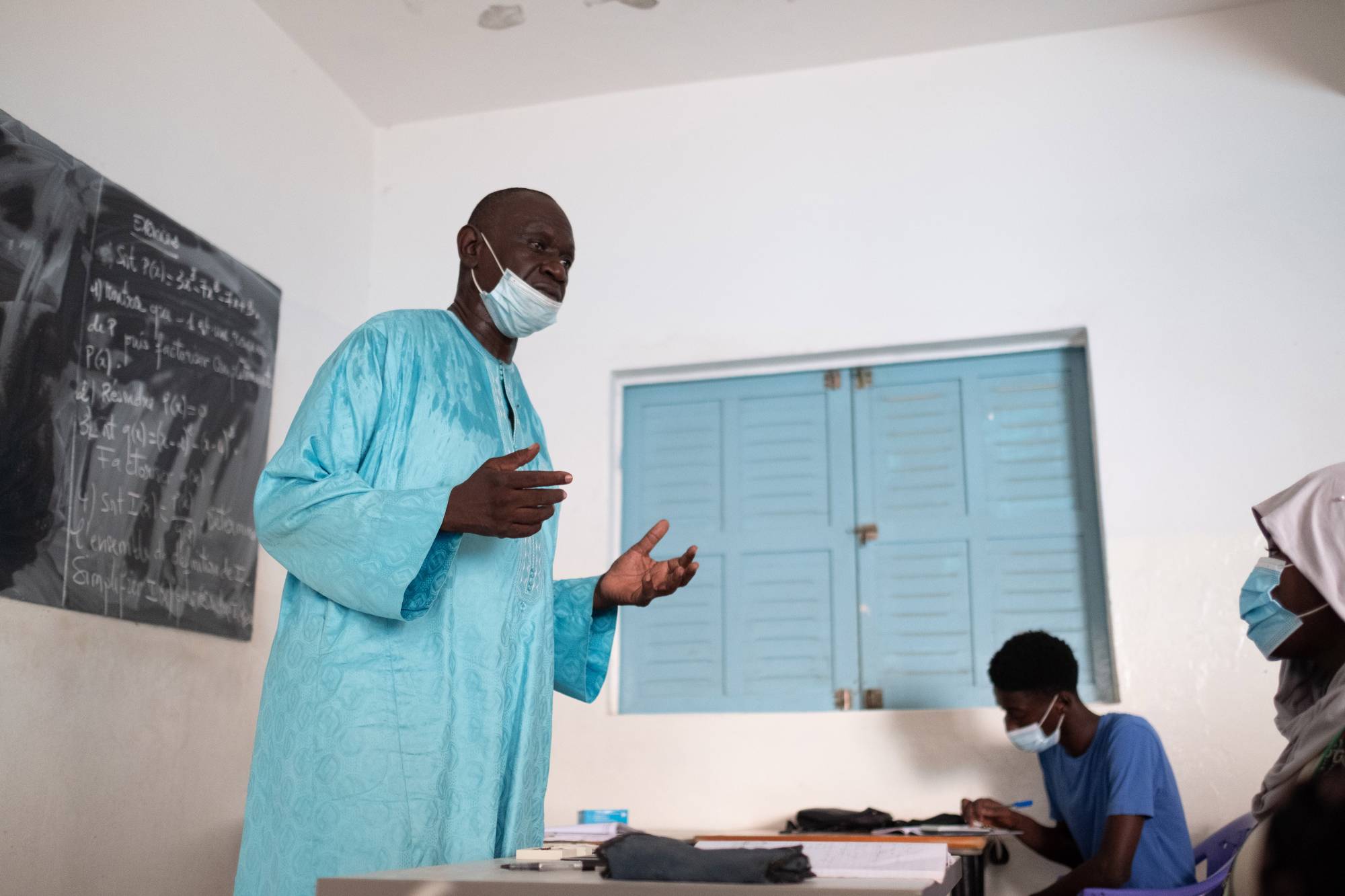 Mbaye Ndiaye, a science teacher, speaks to a class about his inoculation experience in Dakar, Senegal, in September. | Ricci Shryock / The New York Times
