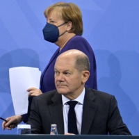 German Chancellor Angela Merkel arrives to address a news conference, together with her designated successor Olaf Scholz, after meeting with heads of government of Germany\'s federal states at the Chancellery in Berlin on Thursday about measures to curb the COVID-19 pandemic. | POOL / VIA REUTERS