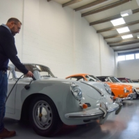 Steve Drummond, co-founder of Electrogenic, which converts classic combustion engine cars to electric, plugs in a converted Porsche in Kidlington, England, on Nov. 9.  | REUTERS