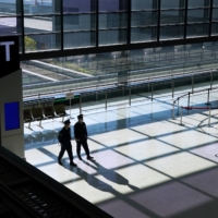 Police officers patrol an empty check-in area in a departure hall at Narita Airport in Chiba Prefecture, Japan, on Tuesday, Nov. 30, 2021.  | BLOOMBERG