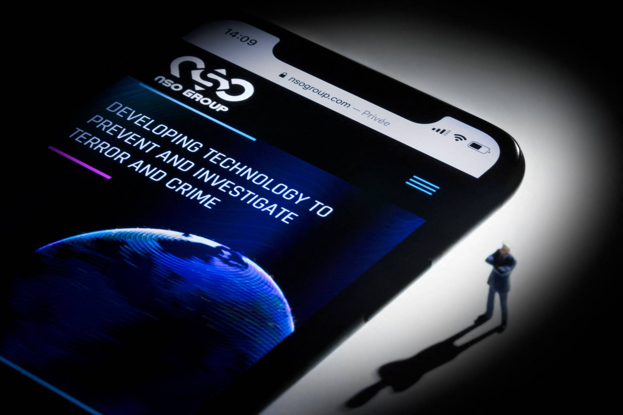This studio photographic illustration shows a smartphone with the website of Israel's NSO Group, which features Pegasus spyware, on display in Paris in July. The Israeli spyware maker in the Pegasus surveillance scandal said Friday that it was investigating reports the firm's technology was used to target iPhones of some U.S. diplomats in Africa.  | AFP-JIJI