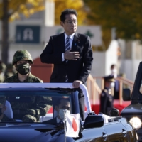 Prime Minister Fumio Kishida reviews Self Defense Forces troops at Camp Asaka in Tokyo on Nov. 27. | BLOOMBERG