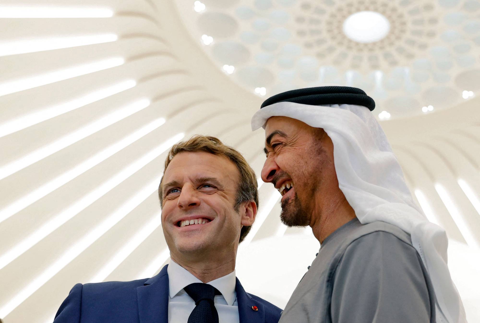 French President Emmanuel Macron and Abu Dhabi Crown Prince Mohammed bin Zayed al-Nahyan tour the French pavilion at the Dubai Expo on the first day of Macron's Gulf tour on Friday. | AFP-JIJI