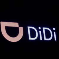 A screen displays trading information for ride-hailing giant Didi Global on the floor of the New York Stock Exchange in New York City. | REUTERS