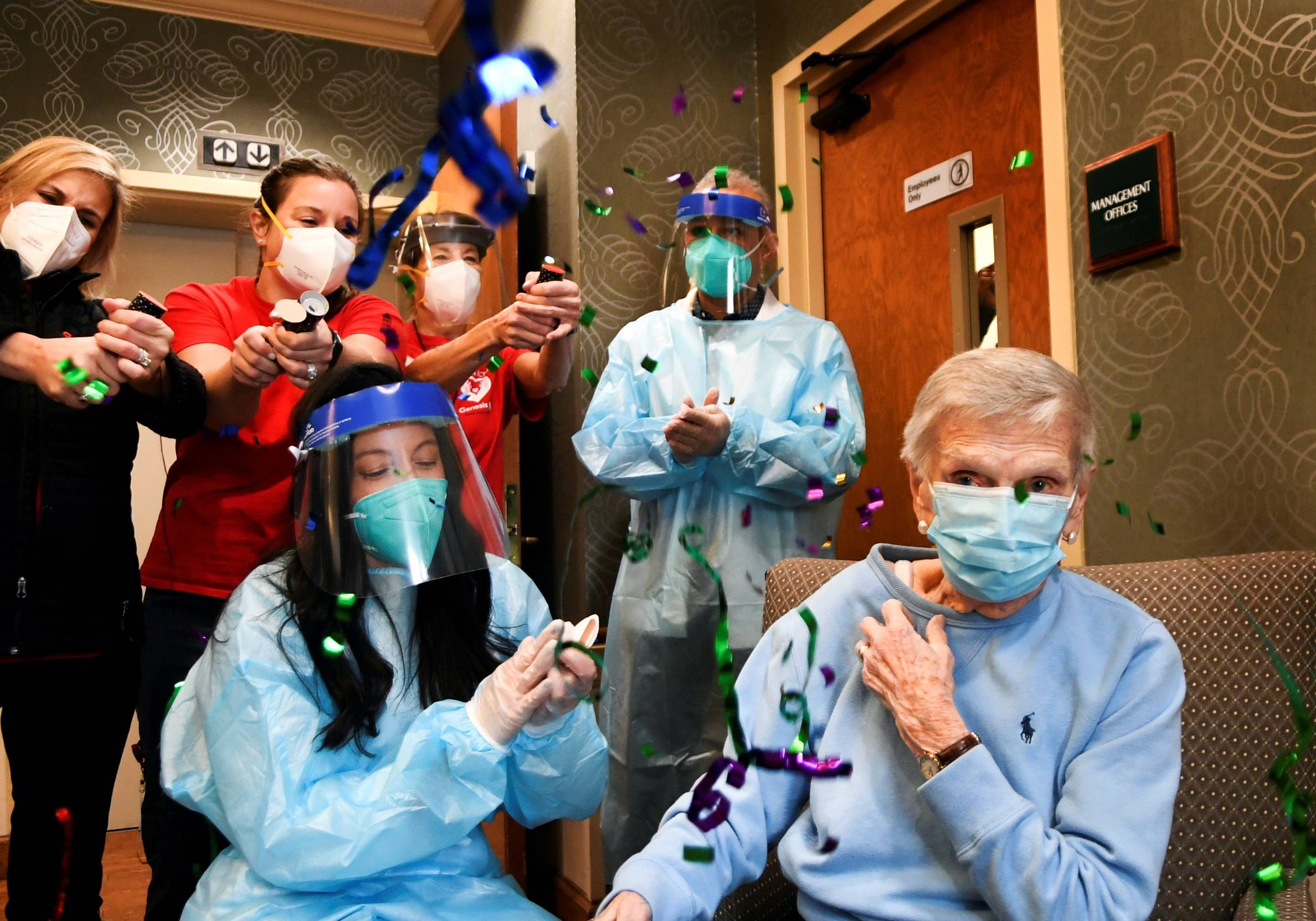 Patients and health care workers at a nursing care facility in West Hartford, Connecticut, celebrate after the administration of the site''s first COVID-19 vaccine dose in December 2020. | Pool via REUTERS