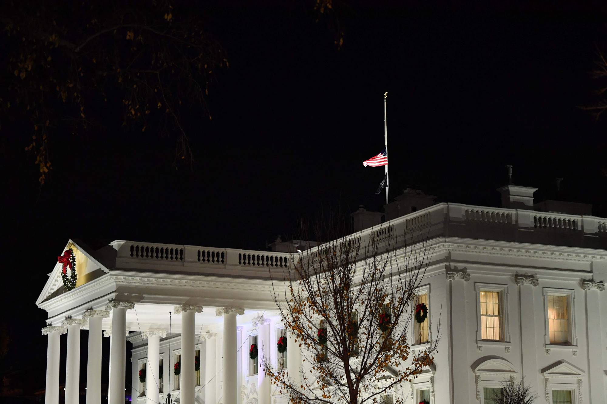 The US national flag flies at half-mast on top of the White House in memory of former Senator Bob on Sunday. | AFP-JIJI