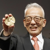 Syukuro Manabe holds his Nobel Prize medal in physics at the National Academy of Sciences in Washington on Monday. | KYODO
