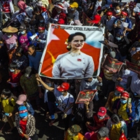Anti-coup protesters carry a portrait of Aung San Suu Kyi during a march in Yangon, Myanmar, on Feb. 13. | THE NEW YORK TIMES