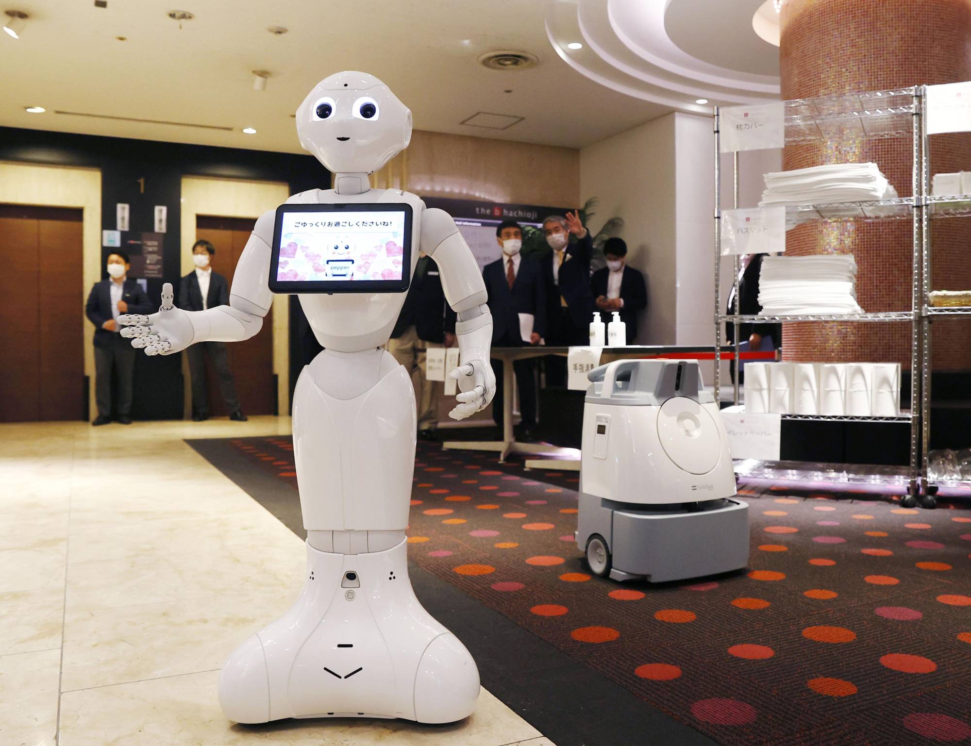 Humanoid robot Pepper at the lobby of a hotel in Tokyo reserved for coronavirus patients with mild or no symptoms in April 2020 | KYODO