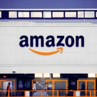The Amazon logo at the company\'s logistics center in Bretigny-sur-Orge, near Paris on Dec. 7, 2021. | REUTERS