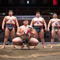 All Japan winner Daiki Nakamura (second from left) and other semifinalists pose for photos during the award ceremony at Ryogoku Kokugikan on Sunday. | JOHN GUNNING
