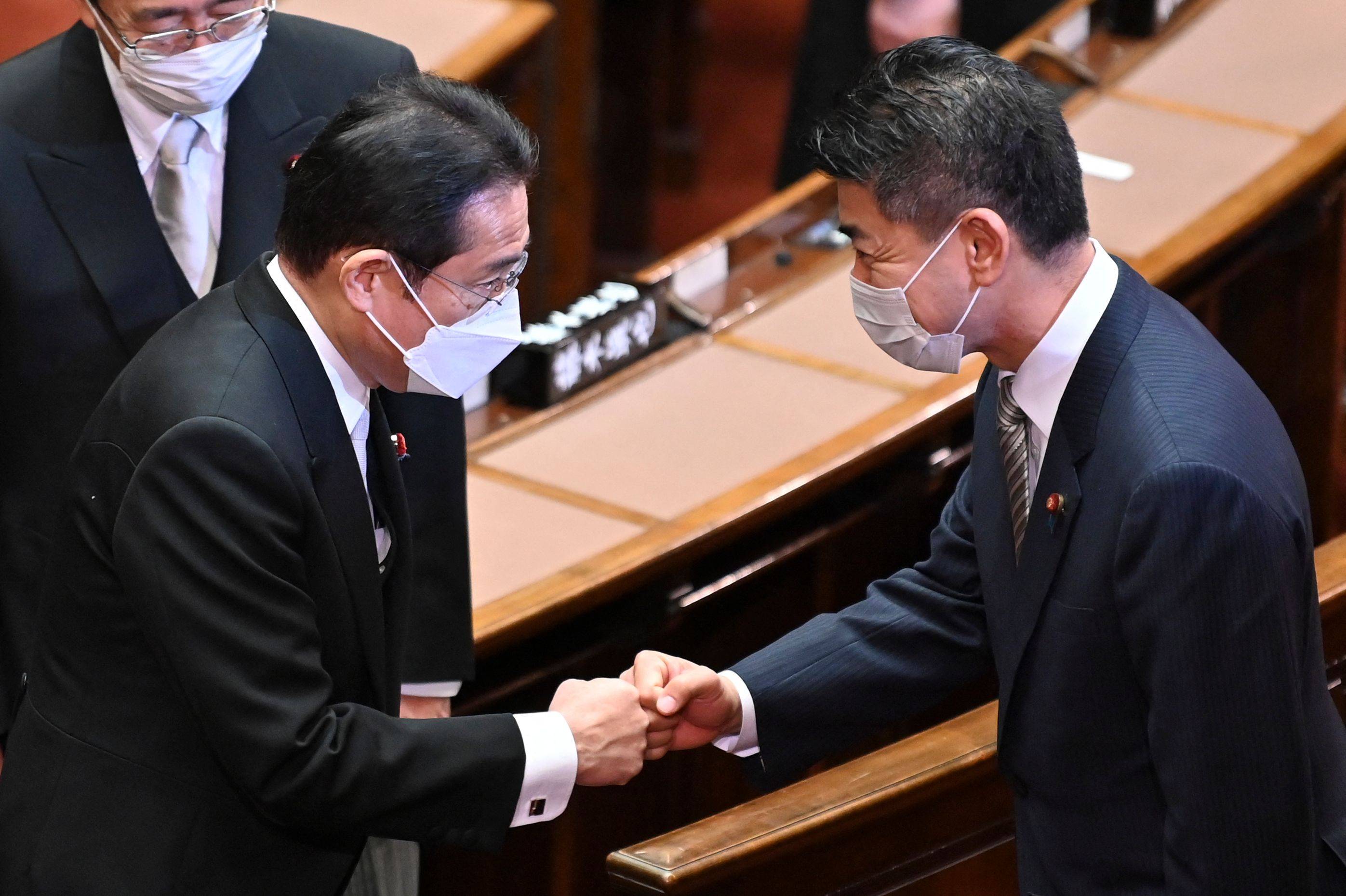 Prime Minister Fumio Kishida and Kenta Izumi, new leader of the main opposition Constitutional Democratic Party of Japan, greet each other after the opening ceremony of an extraordinary session of parliament in Tokyo on Monday. | AFP-JIJI