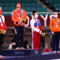 Gold medalist Chizuru Arai (second from left) stands on the podium with the other medalists during the medal ceremony after the women\'s 70-kg judo competition at the Tokyo Games on July 28. | REUTERS