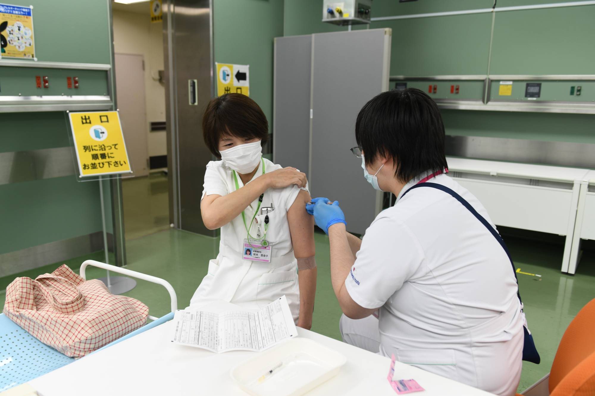 A nurse receives a booster shot of the Pfizer-BioNTech COVID-19 vaccine at Chiba University Hospital on Dec. 1. | BLOOMBERG