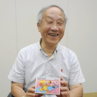 Masayuki Uemura, who developed Nintendo Co.\'s Famicom, or NES, game console, holds a Donkey Kong game during an interview in Kyoto in July 2013. | KYODO