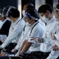 Staffers at an arrival gate of Narita Airport on Nov. 30. | REUTERS