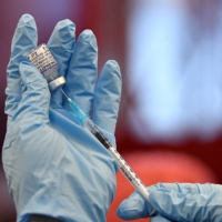 A nurse prepares to administer a shot of the Pfizer COVID-19 vaccine at a clinic in Belfast, Northern Ireland, on Dec. 4.  | REUTERS 